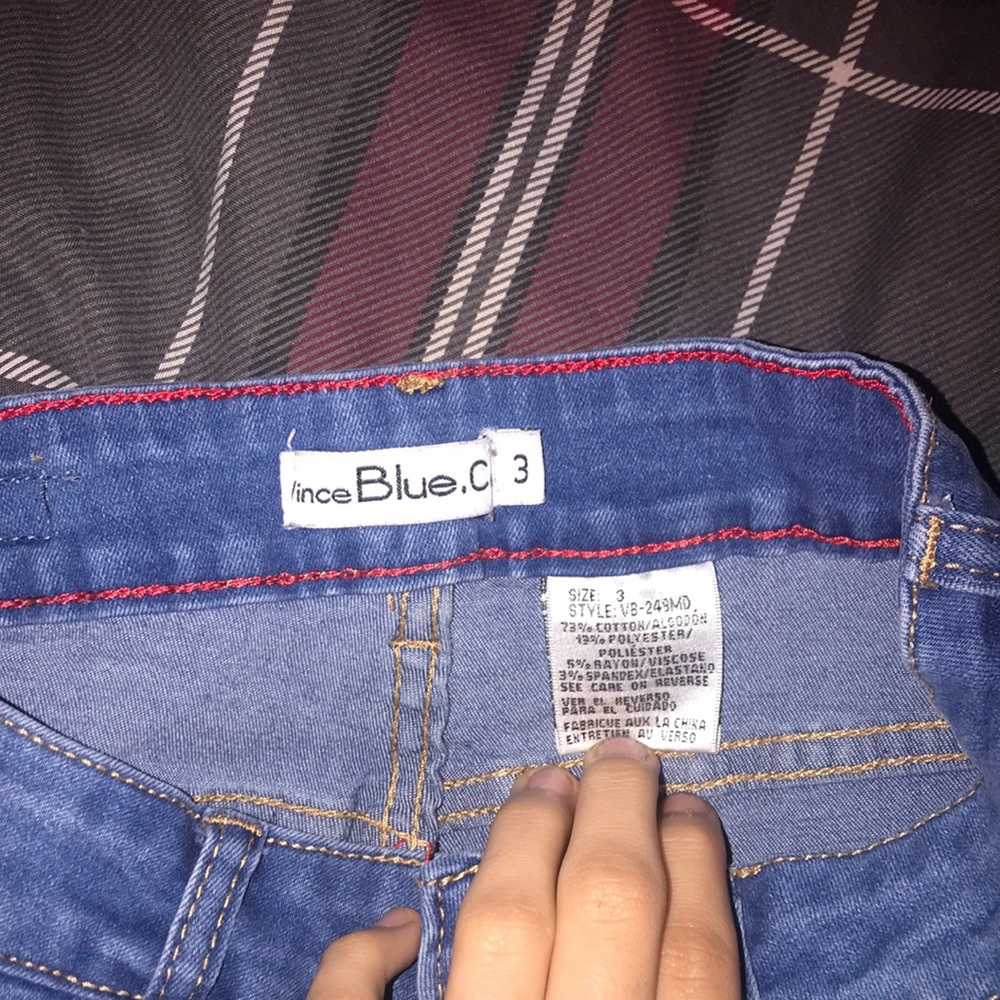 Light blue jeans with rips and pockets on the leg sides